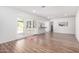 Bright, open-concept living room featuring wood floors and doors leading to the backyard at 624 E Laguna Dr, Tempe, AZ 85282