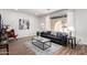 Bright living room with wood floors, large window, and modern decor with stylish furnishings at 624 E Laguna Dr, Tempe, AZ 85282