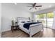 Serene main bedroom with a sliding glass door to the backyard and a ceiling fan for year-round comfort at 624 E Laguna Dr, Tempe, AZ 85282