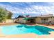 Inviting backyard pool perfect for relaxation and entertaining, with ample deck space and blue sky backdrop at 624 E Laguna Dr, Tempe, AZ 85282