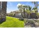 Elegant community entrance featuring stone signage, lush landscaping, and mature palm trees at 7705 E Doubletree Ranch Rd # 21, Scottsdale, AZ 85258