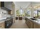 Modern kitchen showcases light wood cabinetry, black appliances, marble backsplash and a clear view of the living area at 7705 E Doubletree Ranch Rd # 21, Scottsdale, AZ 85258