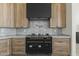 Close up of black and gold oven, marble backsplash, and light wood cabinets in a modern kitchen at 7705 E Doubletree Ranch Rd # 21, Scottsdale, AZ 85258