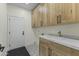 This laundry room has custom cabinets, a gray and white countertop and decorative floor tiles at 7705 E Doubletree Ranch Rd # 21, Scottsdale, AZ 85258