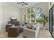 Bright living room featuring large windows, a comfortable sectional sofa and stylish armchairs at 7705 E Doubletree Ranch Rd # 21, Scottsdale, AZ 85258