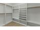 A walk-in closet that features floor-to-ceiling shelving and wooden clothing rods at 7705 E Doubletree Ranch Rd # 21, Scottsdale, AZ 85258