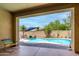 Back patio view of the inviting pool area, landscaping, and patio furniture at 10414 W Windsor Ave, Avondale, AZ 85392