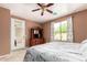 Cozy bedroom with a queen bed, mirrored closet doors, and ample natural light from the window at 10414 W Windsor Ave, Avondale, AZ 85392