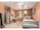 Bedroom with tile floors, ceiling fan, desk, and a neutral paint at 10414 W Windsor Ave, Avondale, AZ 85392