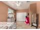 Bedroom with tile floors, ceiling fan, closet and a neutral paint at 10414 W Windsor Ave, Avondale, AZ 85392