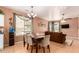 Open-concept dining area with a modern chandelier and views into the living room at 10414 W Windsor Ave, Avondale, AZ 85392