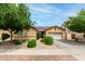 Charming single-story home featuring a two-car garage, desert landscaping, and a well-maintained lawn at 10414 W Windsor Ave, Avondale, AZ 85392