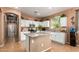 Cozy kitchen features stainless appliances, granite counters, and center island with bar seating at 10414 W Windsor Ave, Avondale, AZ 85392