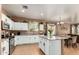 Spacious kitchen featuring white cabinets, stainless steel appliances, and an island with granite countertops at 10414 W Windsor Ave, Avondale, AZ 85392