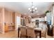 Bright eat-in kitchen features white cabinets, stainless appliances, and a stylish chandelier at 10414 W Windsor Ave, Avondale, AZ 85392