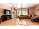Bright living room with large windows, tile flooring, and a comfortable sectional sofa at 10414 W Windsor Ave, Avondale, AZ 85392