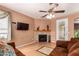Comfortable living room featuring tile floors, fireplace, ceiling fan and neutral paint at 10414 W Windsor Ave, Avondale, AZ 85392