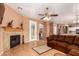 Inviting living room features a cozy fireplace and stylish tile flooring with decorative accents at 10414 W Windsor Ave, Avondale, AZ 85392