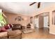 Comfortable living room featuring tile flooring, plenty of seating, and a convenient connection to other rooms at 10414 W Windsor Ave, Avondale, AZ 85392