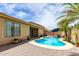 Backyard showcasing a sparkling pool, patio area, palm trees and block wall at 10414 W Windsor Ave, Avondale, AZ 85392