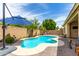 Lovely backyard featuring a sparkling pool, desert landscaping, and a spacious patio at 10414 W Windsor Ave, Avondale, AZ 85392