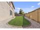 Manicured backyard featuring green lawn and decorative stone landscaping at 1093 E Doral Ave, Gilbert, AZ 85297