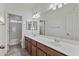 Bathroom featuring a double sink vanity with a large mirror and ample lighting at 1093 E Doral Ave, Gilbert, AZ 85297