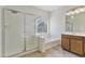 Elegant bathroom featuring a glass-enclosed shower, soaking tub, and stylish fixtures, offering a spa-like experience at 1093 E Doral Ave, Gilbert, AZ 85297