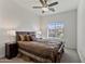 Well-lit bedroom featuring a plush bed, a ceiling fan, and a large window showcasing the neighborhood at 1093 E Doral Ave, Gilbert, AZ 85297