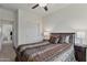 Well-lit bedroom featuring a plush bed with nightstands and ceiling fan at 1093 E Doral Ave, Gilbert, AZ 85297