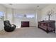 Bright bedroom featuring natural light, a crib, comfortable seating, and warm ambiance at 1093 E Doral Ave, Gilbert, AZ 85297