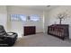 Bedroom with a crib, dresser, and natural light, creating a nurturing and comforting environment at 1093 E Doral Ave, Gilbert, AZ 85297