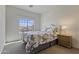 Cozy bedroom with a decorative bed, a nightstand, and a bright window overlooking the neighborhood at 1093 E Doral Ave, Gilbert, AZ 85297