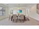 Bright dining room with carpet, stylish lighting, and a glass-top table perfect for Gathering gatherings at 1093 E Doral Ave, Gilbert, AZ 85297