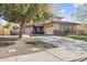 Charming home features a three-car garage and low maintenance landscaping at 1093 E Doral Ave, Gilbert, AZ 85297