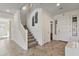 Bright foyer with tiled floors, staircase, and front door, creating an inviting entrance to the home at 1093 E Doral Ave, Gilbert, AZ 85297
