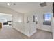 Upstairs hallway featuring neutral carpet, natural light, and a view into the main bedroom at 1093 E Doral Ave, Gilbert, AZ 85297