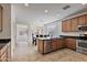 Well-lit kitchen with stainless steel appliances, a breakfast bar, and seamless access to the living area at 1093 E Doral Ave, Gilbert, AZ 85297