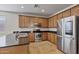 Modern kitchen featuring stainless steel appliances, granite counters, and wood cabinetry at 1093 E Doral Ave, Gilbert, AZ 85297