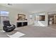 Comfortable living room with neutral carpet, lots of light, and access to the kitchen at 1093 E Doral Ave, Gilbert, AZ 85297