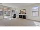 Spacious living room featuring neutral carpet, sliding glass doors, and a media center at 1093 E Doral Ave, Gilbert, AZ 85297