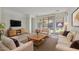 Bright living room with sliding glass doors, plush seating, and a modern media console at 1093 E Doral Ave, Gilbert, AZ 85297