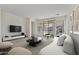 Comfortable living room with sliding glass doors, a sleek entertainment center, and modern decor at 1093 E Doral Ave, Gilbert, AZ 85297