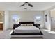 A well-lit bedroom with carpet, ceiling fan, and modern furniture, creating a serene and inviting space at 1093 E Doral Ave, Gilbert, AZ 85297