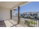 Balcony with wrought iron railing offering street views and a glimpse of nearby townhomes at 11300 N Casa Dega Dr # 1044, Surprise, AZ 85388