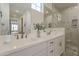 Stylish bathroom featuring a double vanity with white countertops and a walk-in shower at 11300 N Casa Dega Dr # 1044, Surprise, AZ 85388