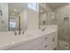 Elegant bathroom with double vanity, white cabinets, and glass-enclosed shower with marble tiling at 11300 N Casa Dega Dr # 1044, Surprise, AZ 85388