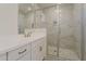 Modern bathroom featuring marble tile, glass shower, and white vanity at 11300 N Casa Dega Dr # 1044, Surprise, AZ 85388