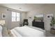 Serene main bedroom with large window, neutral tones, and comfortable seating area at 11300 N Casa Dega Dr # 1044, Surprise, AZ 85388