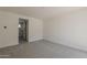 Carpeted bedroom with white paint and connecting doorway leading to a bathroom at 11300 N Casa Dega Dr # 1044, Surprise, AZ 85388